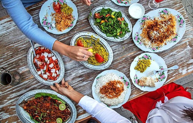 A local food tour guide serving Emirati dishes