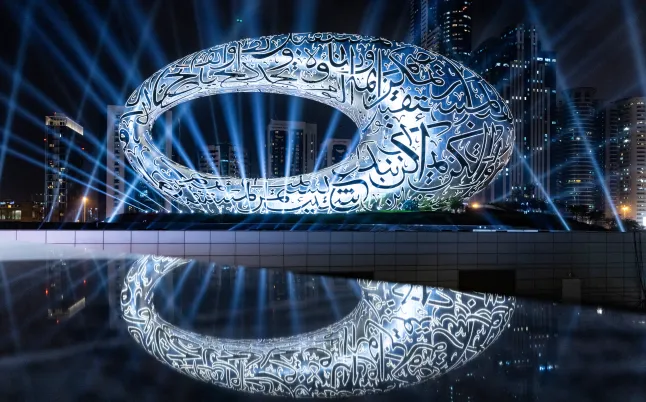 Exterior view of the Museum of the Future glowing at night